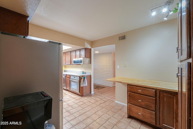 kitchen with appliances with stainless steel finishes and light tile patterned floors