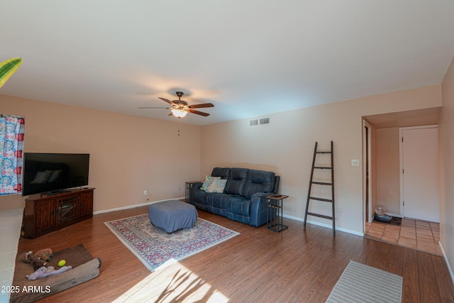 living room featuring hardwood / wood-style floors and ceiling fan