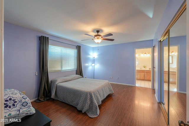 bedroom with hardwood / wood-style flooring, connected bathroom, and ceiling fan