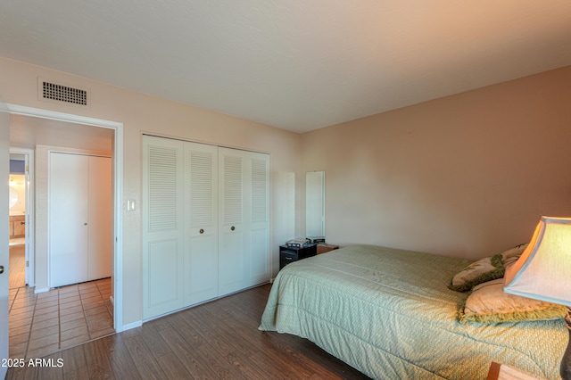 bedroom featuring hardwood / wood-style floors and a closet