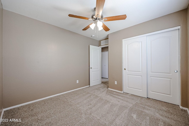 unfurnished bedroom featuring a closet, ceiling fan, and light colored carpet