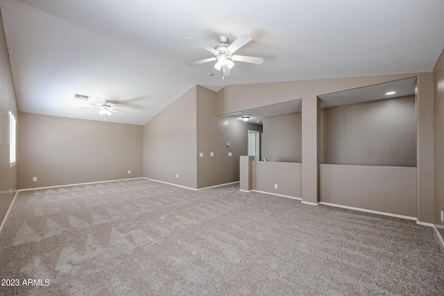 interior space featuring ceiling fan, lofted ceiling, and light carpet