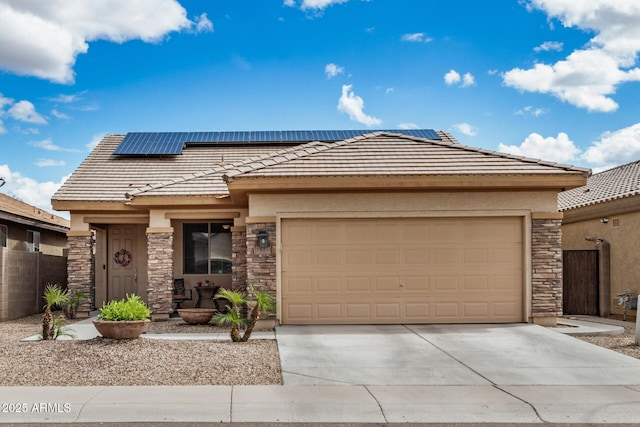 prairie-style home featuring stone siding, driveway, a tile roof, and an attached garage