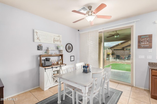 dining space featuring light tile patterned flooring, baseboards, and a ceiling fan