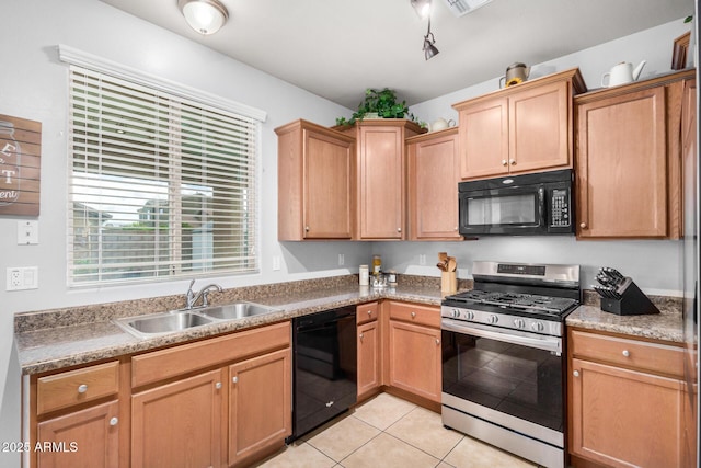 kitchen featuring light tile patterned flooring, black appliances, and a sink