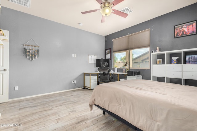 bedroom featuring visible vents, baseboards, and wood finished floors