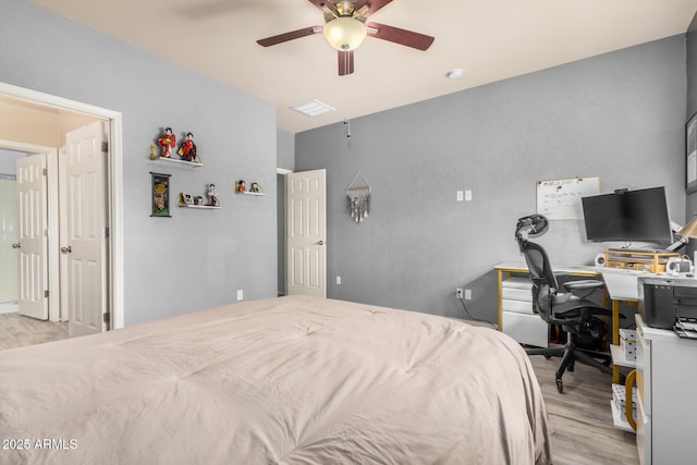 bedroom with light wood-style flooring and a ceiling fan