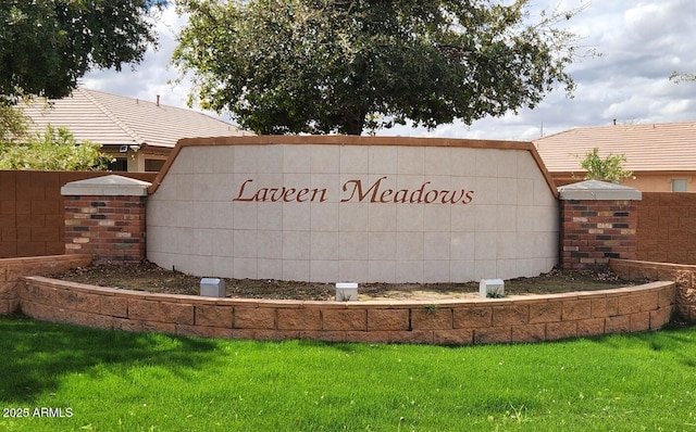 community sign featuring a lawn