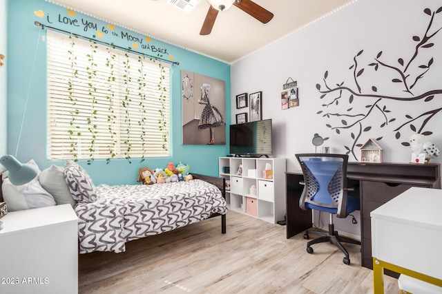 bedroom featuring wood finished floors, visible vents, and ceiling fan