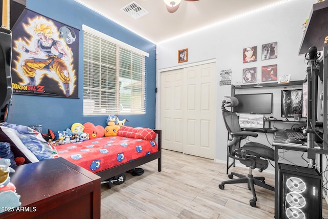 bedroom with visible vents and wood finished floors