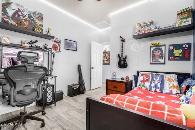 bedroom featuring wood finished floors and visible vents