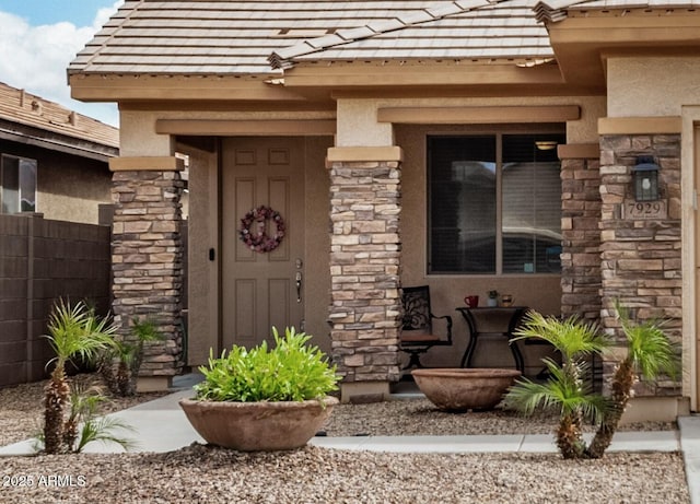 entrance to property with stucco siding and stone siding