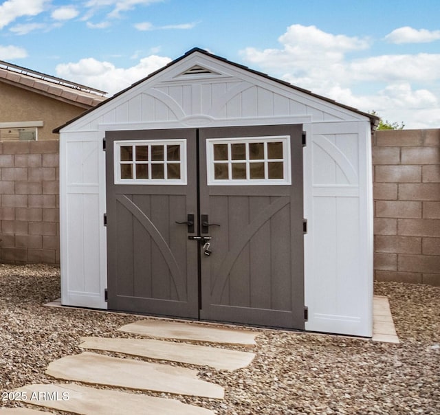 view of shed with fence