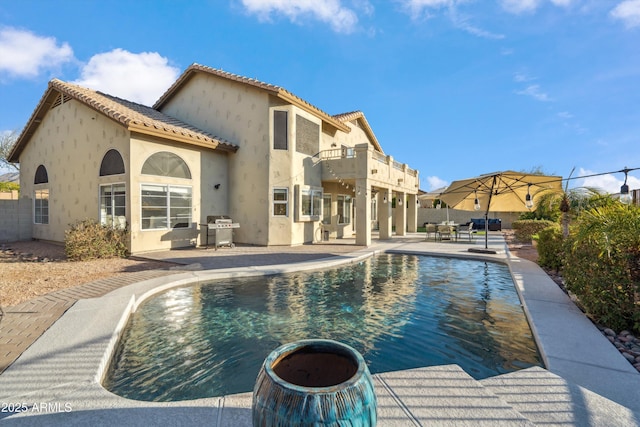 view of swimming pool featuring a patio area, a grill, fence, and a fenced in pool