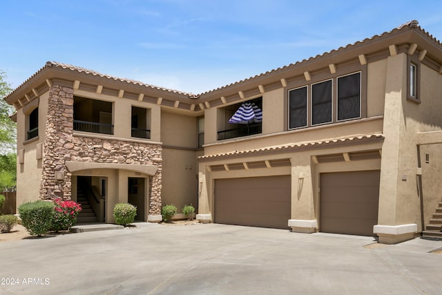 mediterranean / spanish-style home featuring a garage