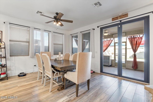 dining area with ceiling fan and light hardwood / wood-style floors