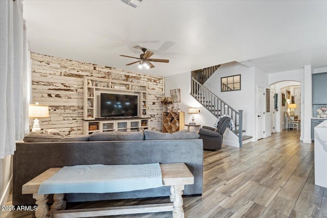 living room with wood-type flooring and ceiling fan