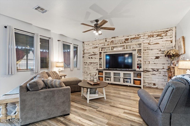 living room featuring ceiling fan and light hardwood / wood-style flooring