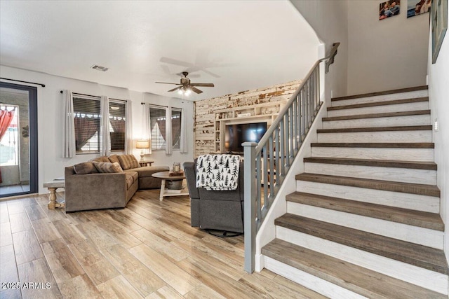 living room featuring ceiling fan and wood-type flooring