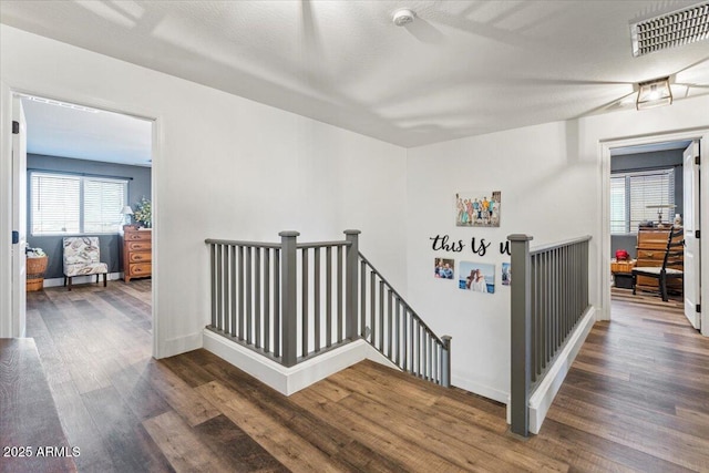 stairway featuring wood-type flooring