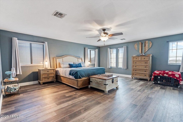 bedroom featuring a textured ceiling, dark hardwood / wood-style floors, and ceiling fan