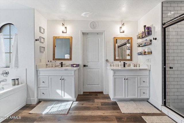 bathroom featuring vanity, wood-type flooring, independent shower and bath, and plenty of natural light