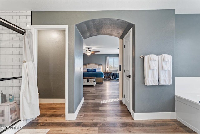 bathroom featuring hardwood / wood-style flooring, ceiling fan, and independent shower and bath