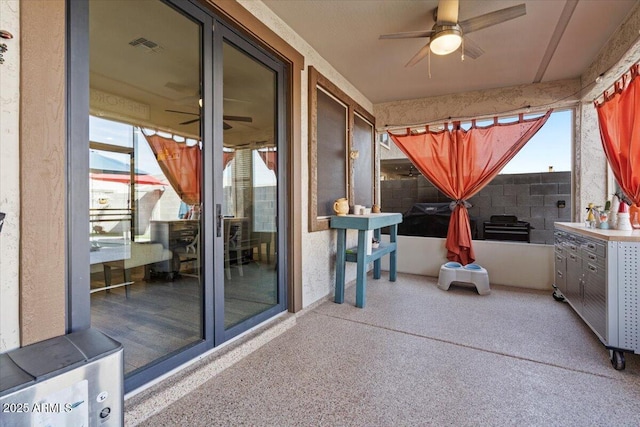 view of patio / terrace featuring ceiling fan and an outdoor kitchen