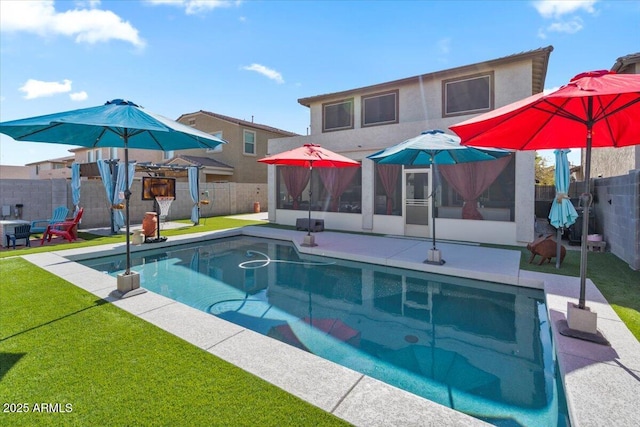 view of swimming pool with a patio, a sunroom, and a yard