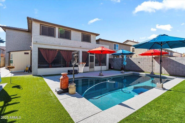 rear view of property with a yard, a fenced in pool, a patio area, and a sunroom