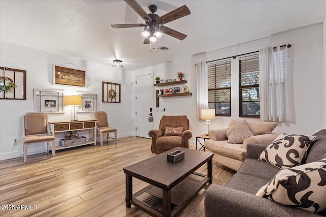 living room featuring light hardwood / wood-style flooring and ceiling fan