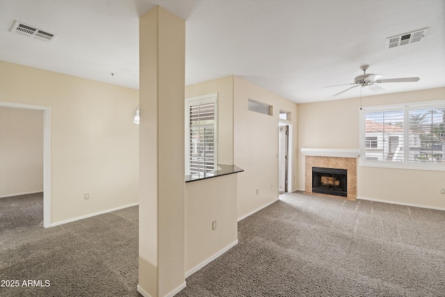 11375 E Sahuaro Dr Unit 2033, Scottsdale, AZ 85259 - unfurnished living room with carpet flooring, a ceiling fan, and a tiled fireplace