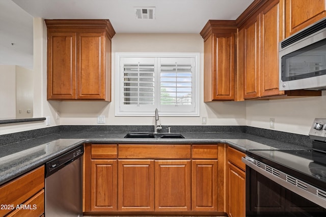 11375 E Sahuaro Dr Unit 2033, Scottsdale, AZ 85259 - kitchen with stainless steel appliances and brown cabinets