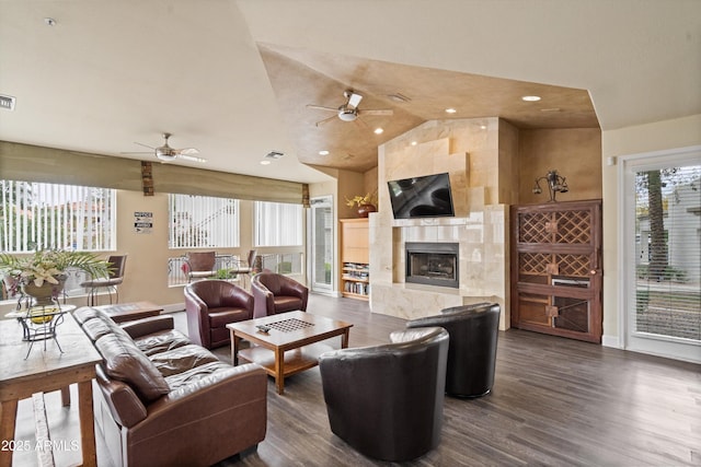11375 E Sahuaro Dr Unit 2033, Scottsdale, AZ 85259 - living area featuring ceiling fan, vaulted ceiling, dark wood finished floors, a tiled fireplace, and recessed lighting