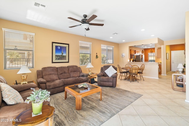 living room featuring ceiling fan, light tile patterned flooring, recessed lighting, visible vents, and baseboards