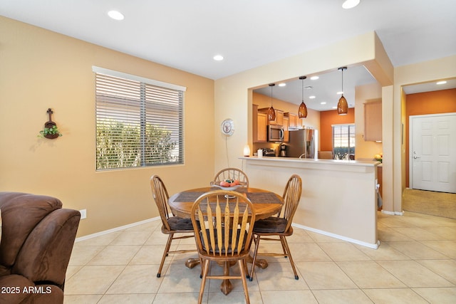 dining room with recessed lighting, light tile patterned flooring, and baseboards