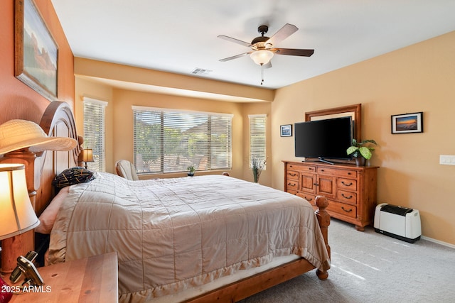 bedroom featuring ceiling fan, carpet flooring, visible vents, and baseboards