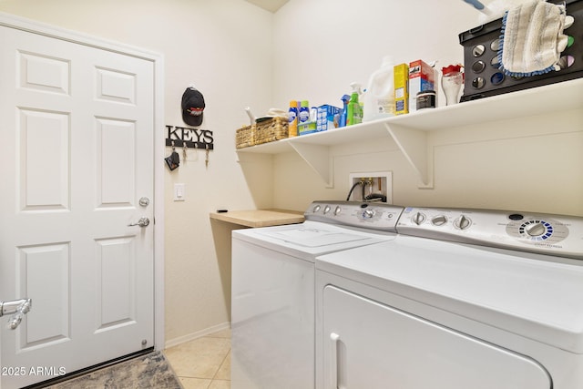 laundry area with laundry area, washing machine and dryer, and light tile patterned flooring