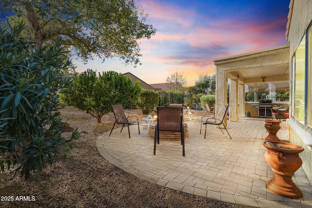 view of patio featuring fence and a grill