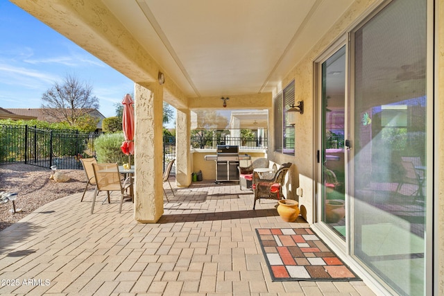 view of patio featuring outdoor dining space, area for grilling, and a fenced backyard