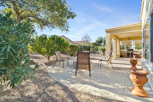 view of patio featuring grilling area and fence