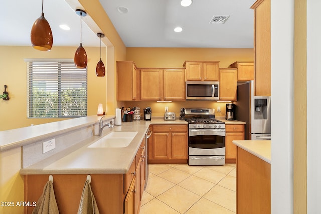 kitchen featuring appliances with stainless steel finishes, decorative light fixtures, sink, kitchen peninsula, and light tile patterned flooring