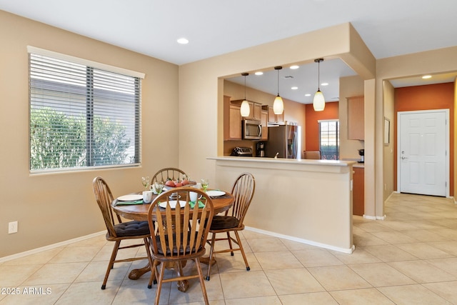 dining area with recessed lighting, baseboards, and light tile patterned floors