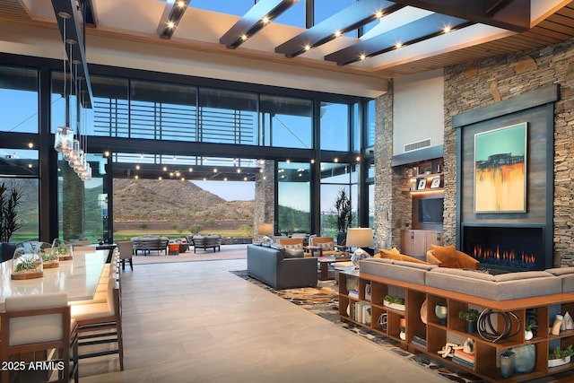 view of patio featuring an outdoor living space with a fireplace and visible vents