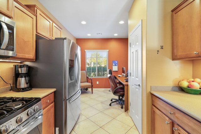 kitchen with light tile patterned floors, visible vents, stainless steel appliances, and light countertops