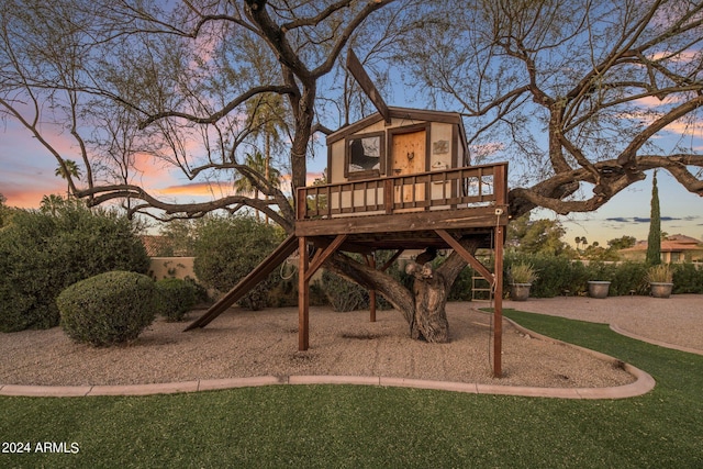 playground at dusk featuring a deck