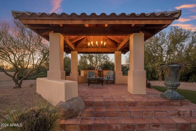 patio terrace at dusk featuring a gazebo