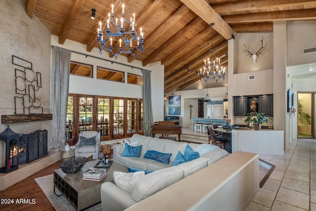 living room with a chandelier, wooden ceiling, high vaulted ceiling, and beam ceiling