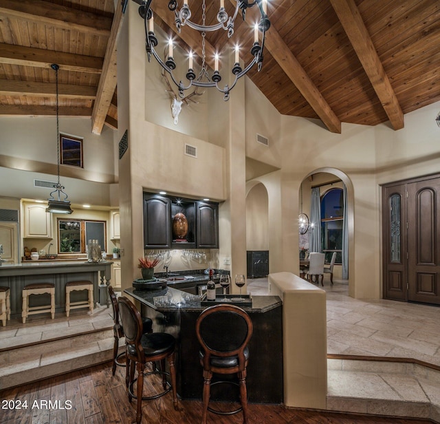 dining space with arched walkways, wooden ceiling, beam ceiling, and visible vents