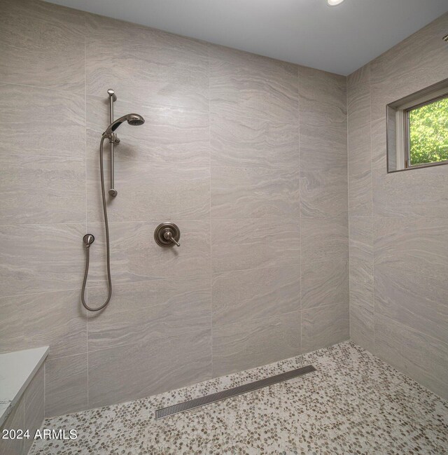 bathroom with a tile shower